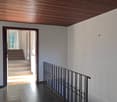 corridor, staircase, black tiles, wooden ceiling, black railing