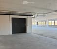 empty, concrete floor, steel beams, white walls, double door