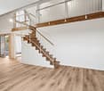 Modern house, wooden floors, white walls, glass doors, staircase, kitchen area, white cabinetry