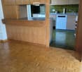 kitchen with wooden floors, wooden cabinets, sink, and dishwasher
