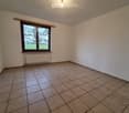 empty room, white walls, brown tile floor, window, no furniture