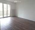 empty room, wooden floor, sliding glass door, balcony, white walls, white radiator