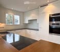 modern kitchen with white cabinets, stainless steel appliances, granite countertop, double sink, windows