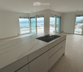 modern kitchen with marble countertop, black induction hob, white cabinets, sliding glass doors, balcony, panoramic view