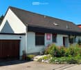 single family house, white paint, brown roof, wooden garage door, garden, flower beds