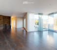 tiled floor, large windows, glass doors to balcony, stone wall