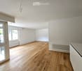 empty room, hardwood floors, large windows, two white radiators, sliding door with balcony