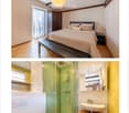 Cozy bedroom with wooden floor, exposed wooden beams, large window with white curtains, bed with pillows and blanket, nightstand, and wardrobe.