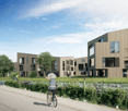 Modern multi-story residential building with large windows and wooden facade, surrounded by greenery and a pathway.