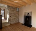 wooden floor, wooden ceiling, stone wall, fireplace, glass door