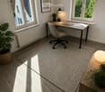 Bright, modern home office with large windows, wooden flooring, a desk with a laptop, a chair, a lamp, and decorative plants.