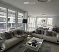 two couches, glass table, two lamp bases, dining table, two windows