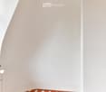 Empty room with white walls and a red hexagonal tile floor. No furniture or equipment visible.