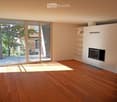 Empty room with wooden flooring, large sliding glass doors leading to a balcony, and a built-in fireplace unit with shelves.