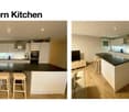 Modern kitchen with white cabinets, black countertops, and a central island with stools. Features include an oven, sink, and various kitchen appliances.