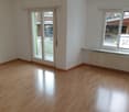 wooden floor, white walls, glass doors, windows, balcony, radiator