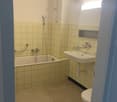 white tiled walls, bathtub, shower, sink, toilet
