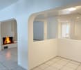 Empty room, fireplace, tiled floor, glass windows, mirror