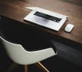 wooden desk, white chair, laptop, mouse