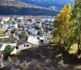 Town landscape, multiple houses, trees, mountains