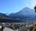 Aerial view of town with buildings, mountains, and clear sky
