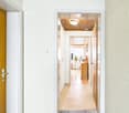 Raised ground floor, Two wooden doors, white wall, wooden floor, wooden ceiling