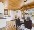 kitchen with dining area, wooden ceiling, tiled floor, wooden dining table with chairs, balcony, sliding doors, mountain view
