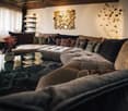L-shaped sofa, glass table, decorative wall art, large windows, decorative pillows, floor lamp