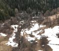 hilly terrain, snow patches, trees, shrubs, open space