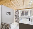 Bathroom with white tiles, wooden ceiling, shower, sink, and window
