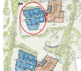 The image shows a floor plan of a building complex. The circled area appears to be a parking lot or garage. The overall plan includes multiple buildings, green spaces, and other facilities.