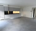Empty kitchen, modern kitchen with gray cabinets, tiled floor, white appliances, and sink with faucet