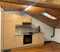 wooden floor, ceiling, kitchen cabinets, stove, oven, sink, wooden countertop, window