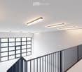 Interior view with a staircase and large windows, white walls and floor
