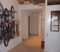 bicycles hung from wall, chandelier, tiled floor, wardrobe, closed door