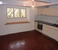 kitchen with white cabinetry, black counter, gas stove, small window, tiled flooring
