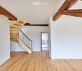 empty room, wooden stairs, wooden beams on ceiling, hardwood floor