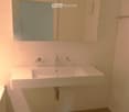 White tiles, single sink, modern design, glass soap dispensers