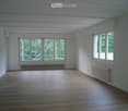 empty room with wooden floor, white walls, large windows, radiators