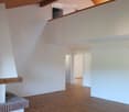 empty room, hardwood floors, white walls, wooden ceiling, fireplace, balcony