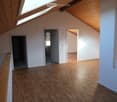 empty room, wooden floors, attic ceiling, white walls, windows