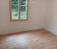 wooden floor, large window, white walls, garden view