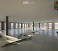Empty room, multiple windows, high ceiling, construction materials scattered on the floor