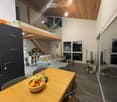 Open plan, modern furniture, wooden table, balcony, dining area, open kitchen, loft stairs