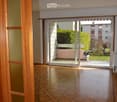 Empty room with sliding glass doors leading to a balcony