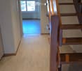 wooden staircase, wooden flooring, ceiling lights, open room with windows and radiator, hallway