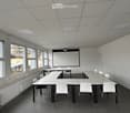 empty room, white walls, white ceiling, white tables, white chairs, projector screen, windows