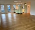 empty room, wooden floor, white walls, glass doors, kitchen with sink and cabinets, balcony