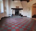 empty room, fireplace, checkered floor, white walls, arched windows, open door
