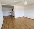 empty room, wooden floor, white walls, kitchen area, power outlet